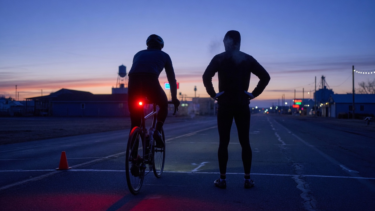 Athletes at a small start line just before sunrise.